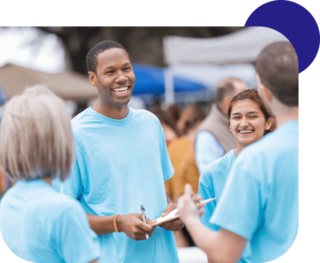 Smiling volunteers at community event.