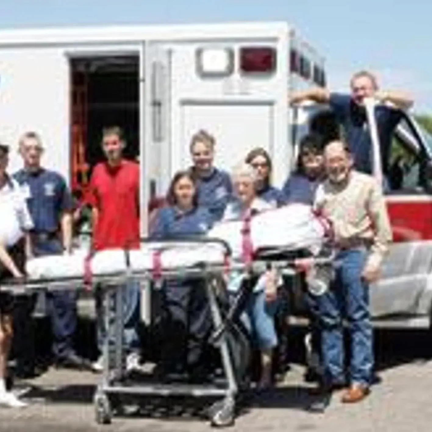 Paramedics and patients near ambulance.