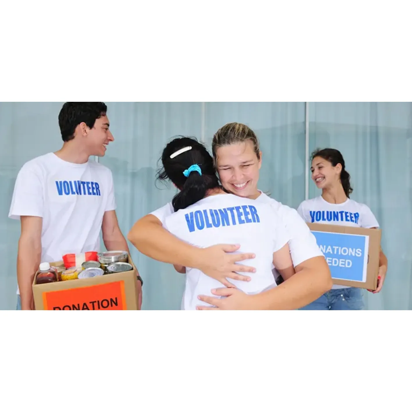 Volunteers hugging, donating food.