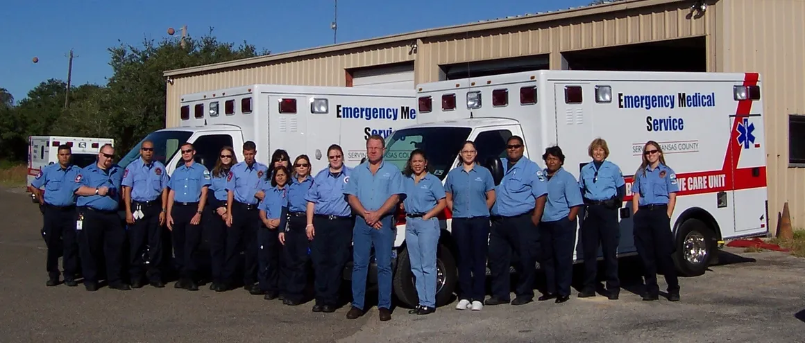 EMS team posing by ambulances.