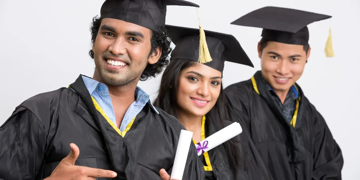 Proud graduates holding diplomas.