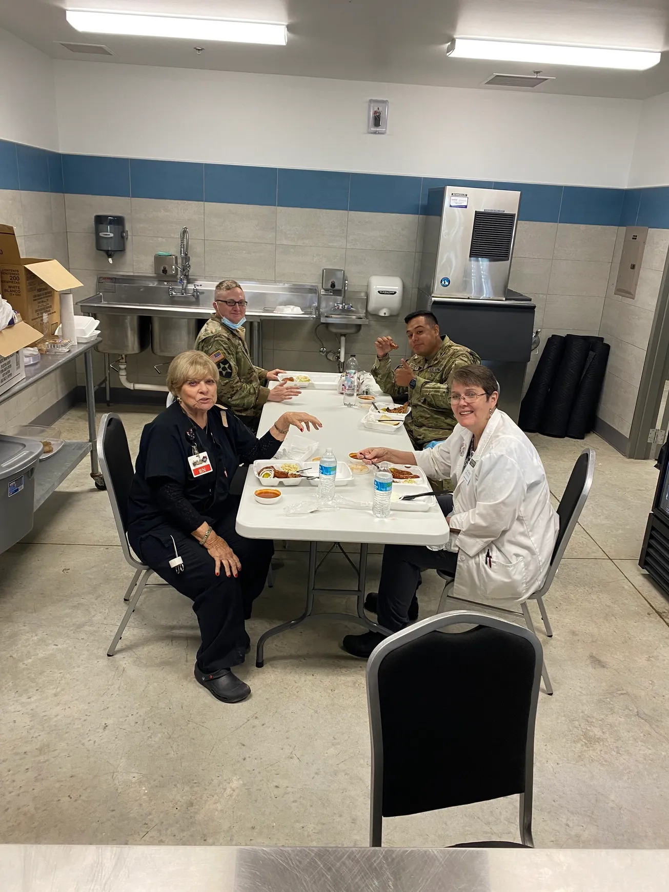 Four people eating lunch together.